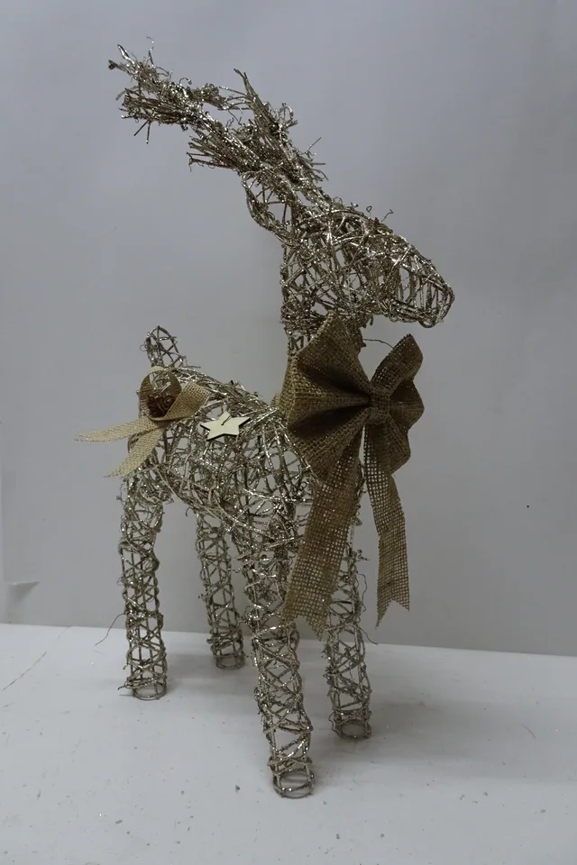 Rattan reindeer with burlap bow and wooden star decoration.