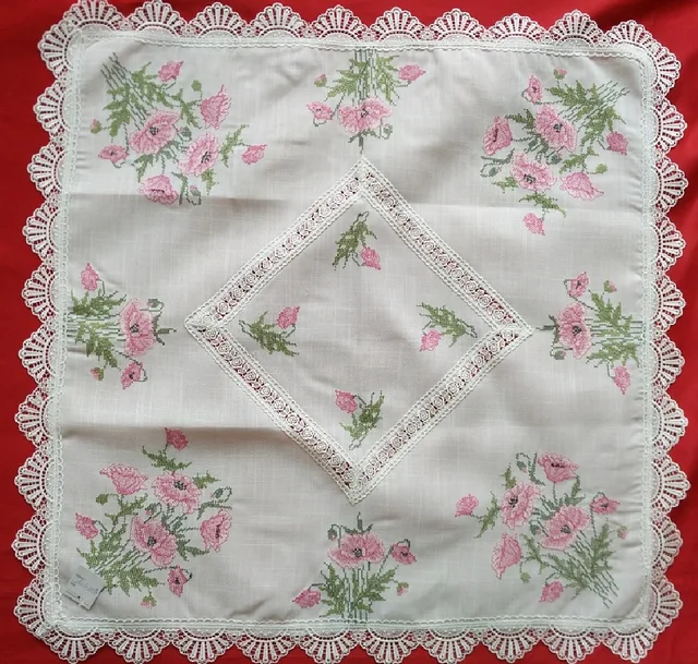 Cross-stitch poppy embroidery with lace table cloth