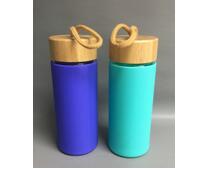 Glass water bottle with bamboo lid and silicone sleeve